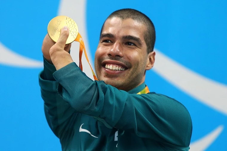 Daniel Dias, um dos maiores atletas paralímpicos brasileiros, mostrando medalha de ouro